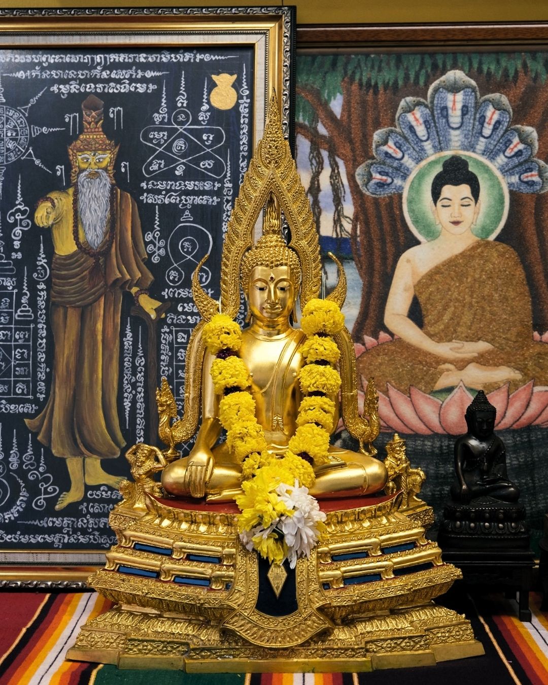 Sacred altar with Buddha statues and Thai yantra cloths