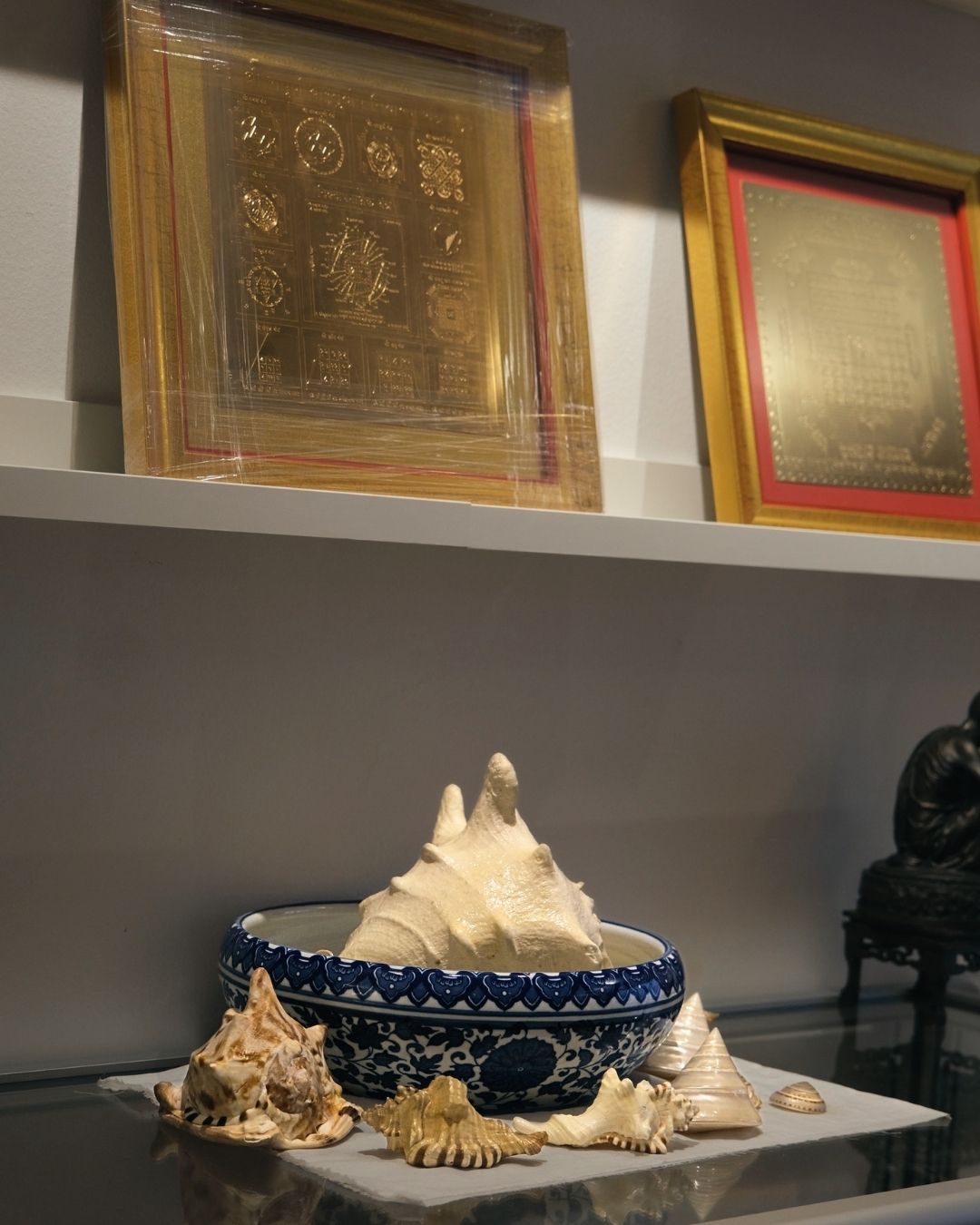 Framed gold yantras on wall